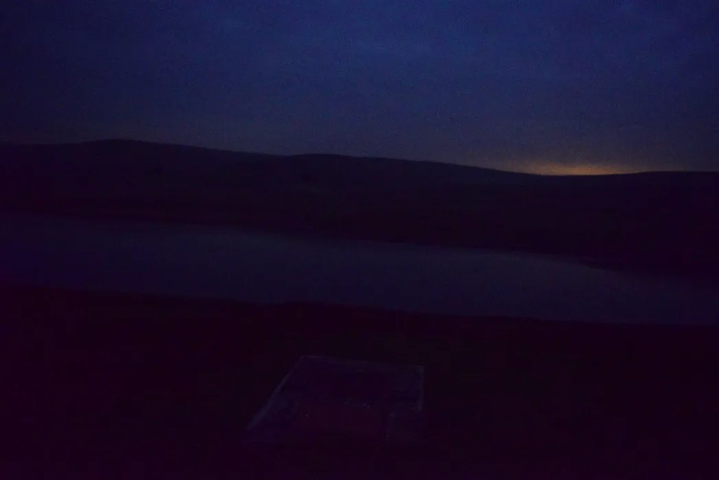 View on the Craig Goch lake and Aberystwyth light glow beyond