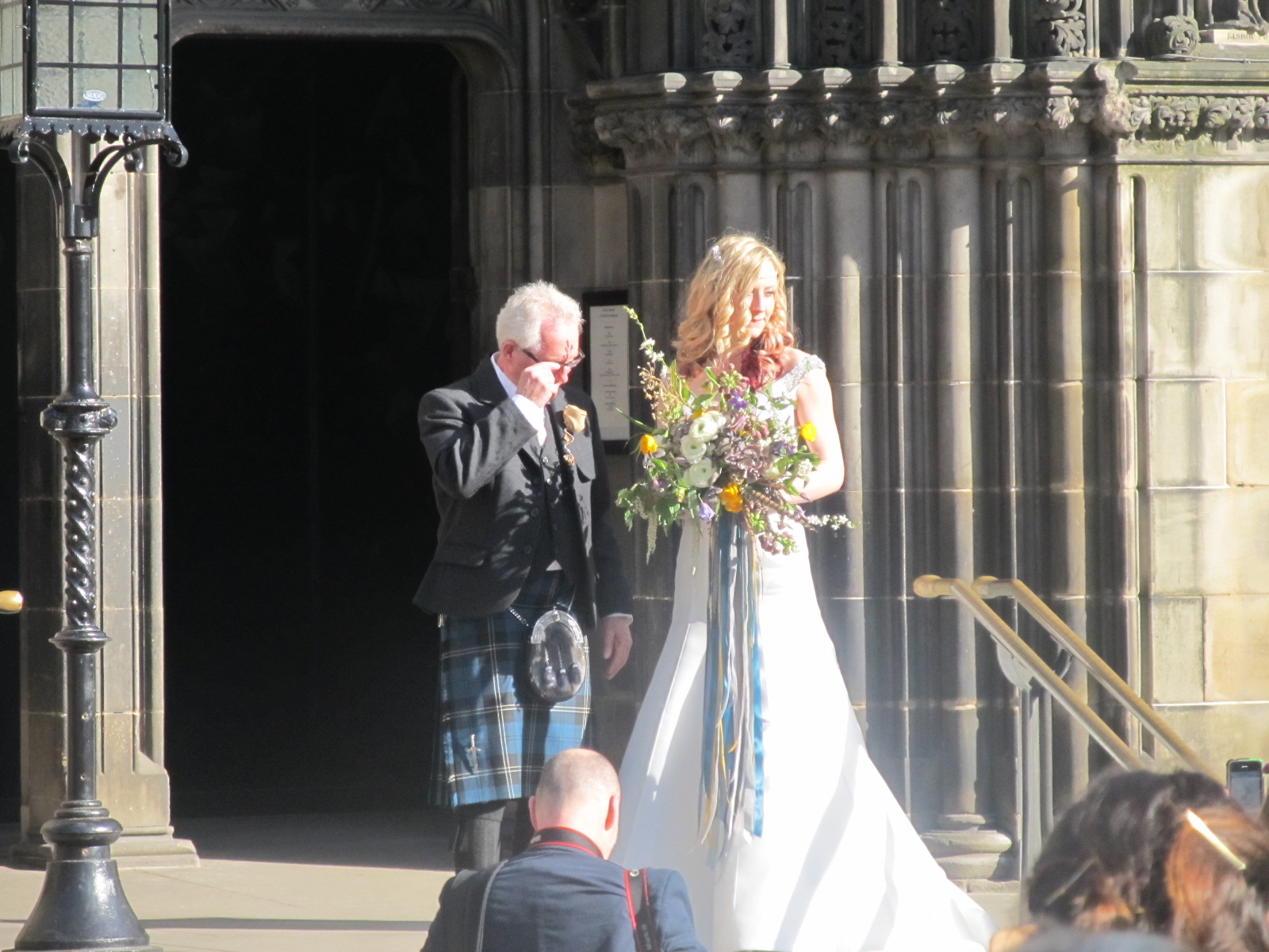 Edinburgh, St Giles Cathedral and groom with scottish kilt at the front door